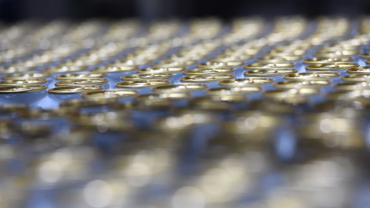 Close-up of stacked metal coils or industrial equipment components with blue accents and shallow depth of field focus.