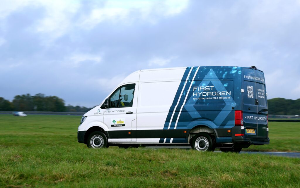 First Hydrogen fuel cell electric van in motion on a test track with "The Future With Zero Emissions" branding visible on ...