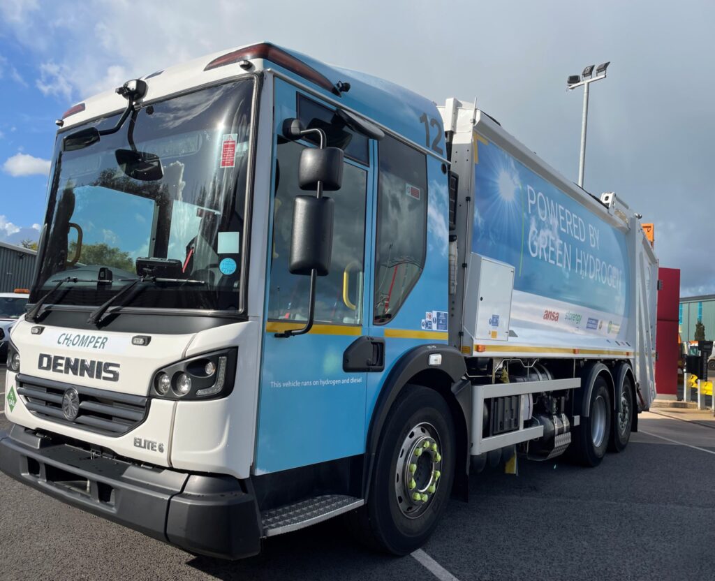 Hydrogen fuel cell truck with "Powered by Green Hydrogen" livery, demonstrating zero-emission heavy transport technology f...
